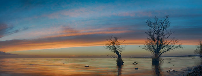 Scenic view of lake against sky during sunset