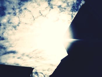 Low angle view of silhouette building against sky