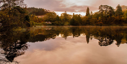 Scenic view of calm lake against cloudy sky