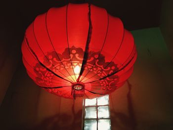 Low angle view of illuminated lanterns hanging from ceiling