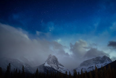 Scenic view of mountains against sky at night