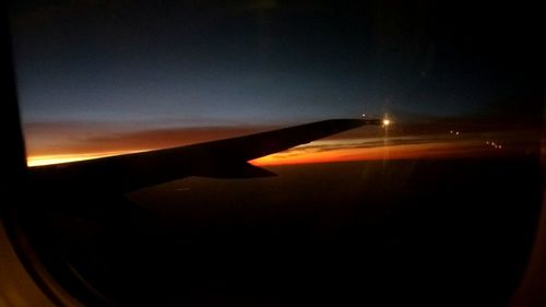 Airplane on runway against sky at night