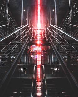 View of illuminated escalator at night