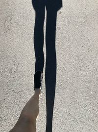 Low section of person standing on shadow