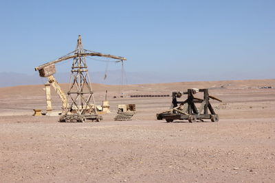 Traditional windmill on field against clear sky