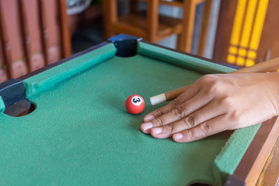 Cropped hand playing pool