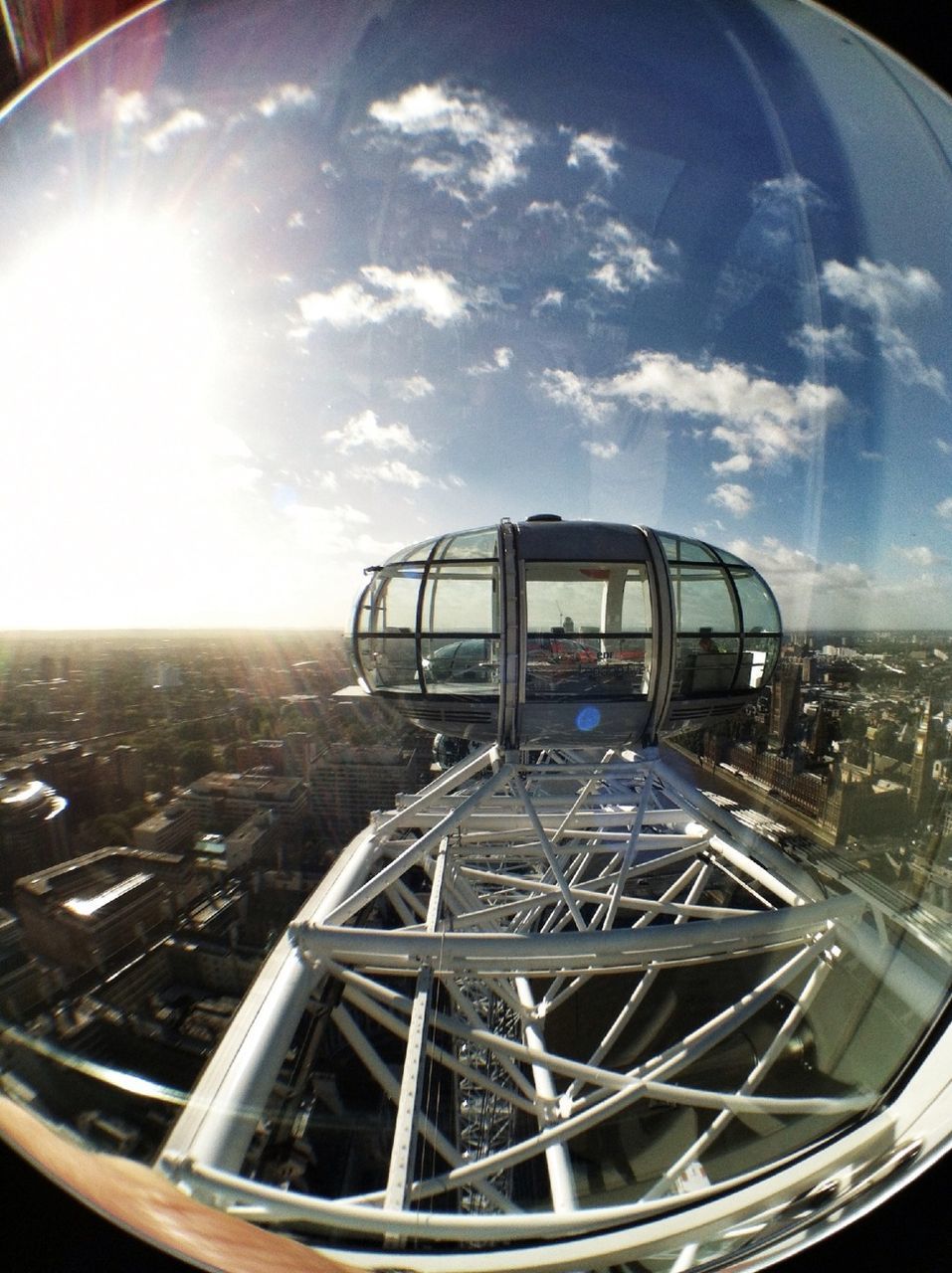 glass - material, transparent, fish-eye lens, transportation, sky, window, architecture, mode of transport, built structure, cloud - sky, city, car, indoors, vehicle interior, reflection, land vehicle, airplane, building exterior, sunlight, cloud