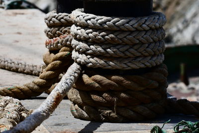 Close-up of rope tied to wooden post