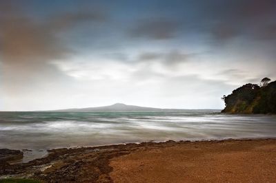 Scenic view of sea against cloudy sky