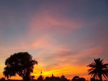 Low angle view of silhouette trees against sky during sunset