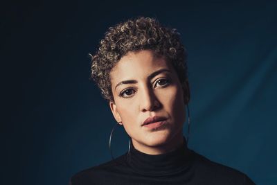 Portrait of woman against black background