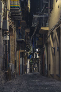 Street amidst buildings in city at night