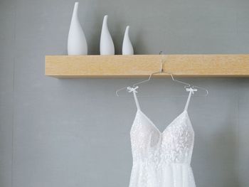 Close-up of clothes hanging against white wall