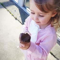 High angle view of girl holding ice cream on road