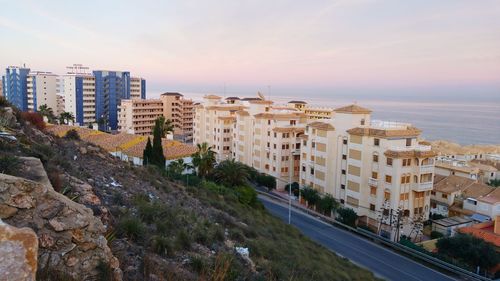 High angle view of road by buildings against sky