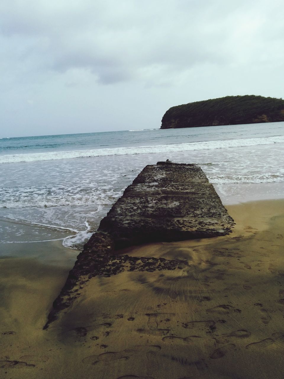 sea, beach, water, horizon over water, sky, shore, tranquility, tranquil scene, scenics, sand, cloud - sky, nature, beauty in nature, built structure, rock - object, coastline, idyllic, outdoors, cloud, day