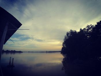 Scenic view of lake against sky at sunset