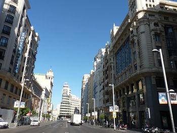 Panoramic view of city street against clear sky