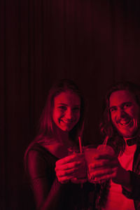 Couple sharing a drink in a night club