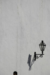 Low angle view of street light mounted on wall