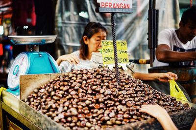 Mother and daughter for sale at market stall