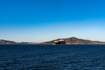 Scenic view of sea against clear blue sky