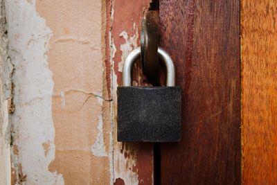 Close-up of padlock on metal door