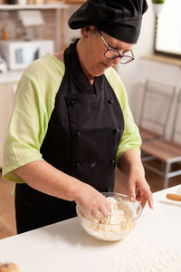 Midsection of man preparing food