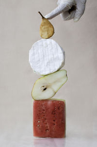 Midsection of person holding apple against white background