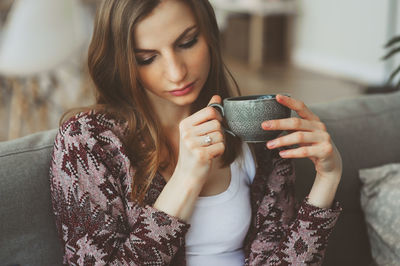 Close-up of young woman using smart phone