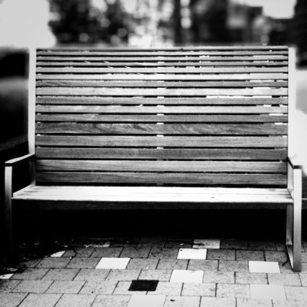 building exterior, built structure, architecture, pattern, focus on foreground, bench, outdoors, cobblestone, day, empty, sidewalk, sunlight, no people, in a row, close-up, steps, wood - material, absence, selective focus, footpath