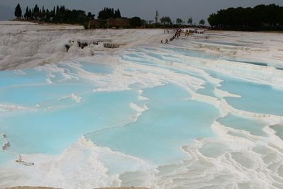 Scenic view of snow covered land against sky