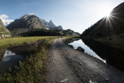 Scenic view of lake and mountains against sky