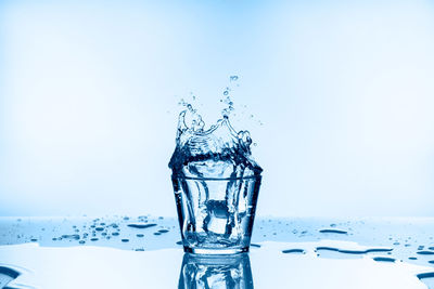 Close-up of water splashing against blue background