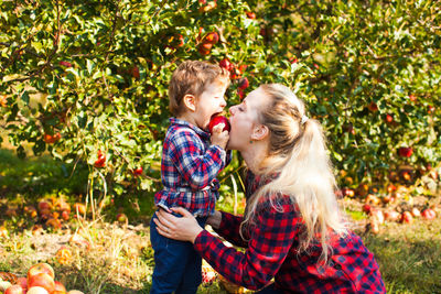 Mother and daughter against plants