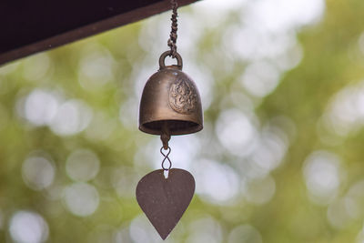 Close-up of bell hanging against blurred background