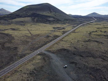 High angle view of road amidst mountains against sky