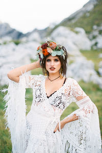 Portrait of woman standing on grass