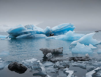 Aerial view of icebergs on snow covered landscape against sky