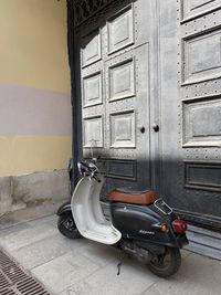 Motor scooter by building in city
