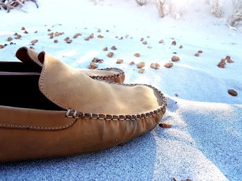 High angle view of shoes on sand 