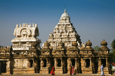 Group of people in temple against clear sky