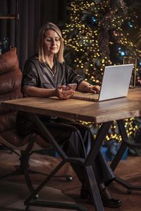 Young woman using laptop at home
