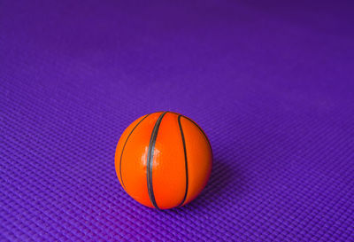 Close-up of orange ball against blue background