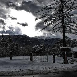 Scenic view of mountains against cloudy sky