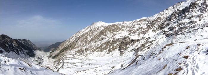 Snow covered mountain range against sky