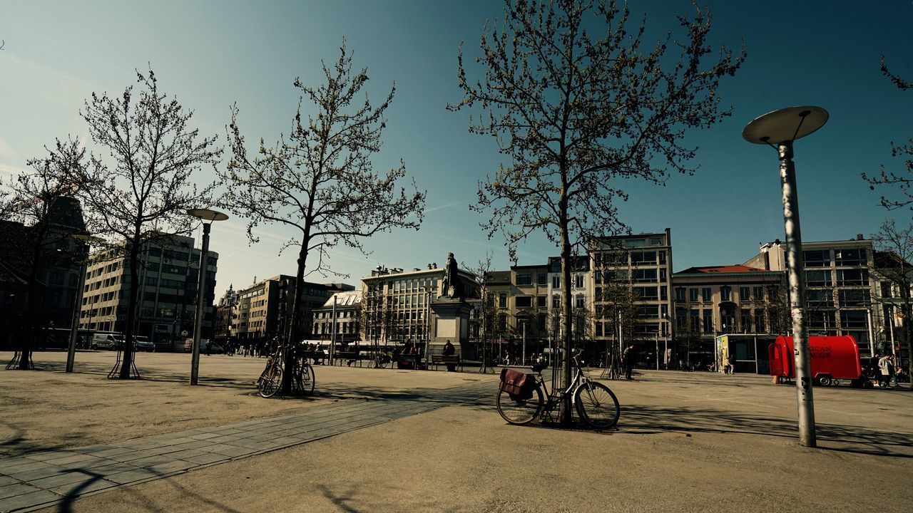 BICYCLES ON STREET BY BUILDINGS IN CITY