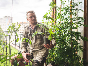 Young man looking at plants