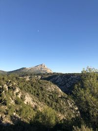 Scenic view of rocky mountains against clear blue sky