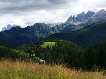 Scenic view of mountains against cloudy sky